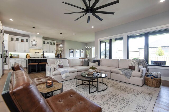 1510 N Lake Edge Dr, Springfield, MO 65802 - living room featuring light wood-type flooring, recessed lighting, ceiling fan, and a chandelier