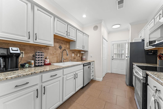 110 Cottonwood Trl Unit 2D, Branson, MO 65616 - kitchen featuring appliances with stainless steel finishes, ornamental molding, white cabinetry, decorative backsplash, and light tile patterned floors