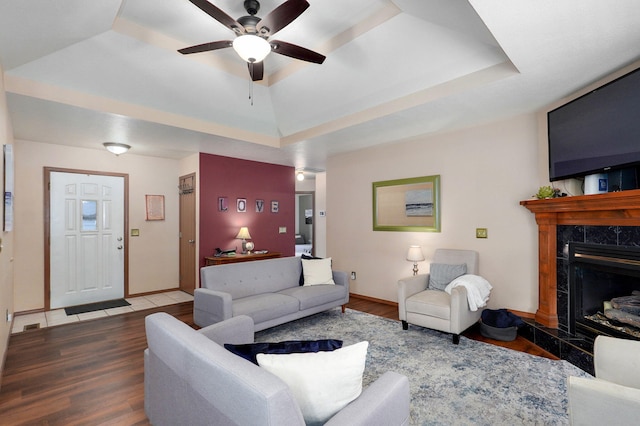 608 S Ashwood Ct, Nixa, MO 65714 - living area featuring a raised ceiling, wood finished floors, and a premium fireplace
