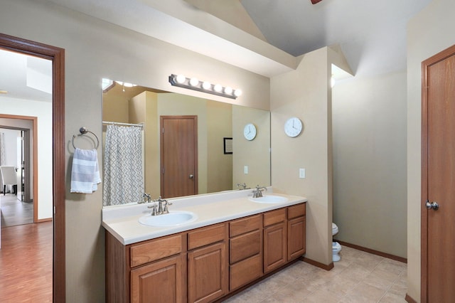 608 S Ashwood Ct, Nixa, MO 65714 - bathroom with double vanity, a shower with curtain, and lofted ceiling