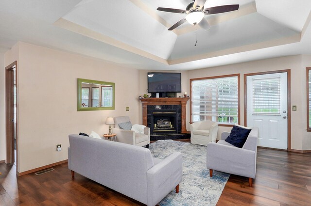 608 S Ashwood Ct, Nixa, MO 65714 - living area featuring a tray ceiling, dark wood-style floors, a high end fireplace, and ceiling fan