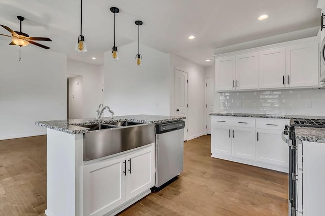 921 S Deerfield Ct, Nixa, MO 65714 - kitchen featuring stainless steel appliances, ceiling fan, white cabinets, light wood finished floors, and backsplash