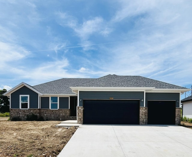 921 S Deerfield Ct, Nixa, MO 65714 - prairie-style house featuring a garage, stone siding, and driveway