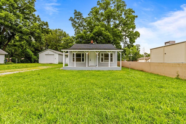 1024 N Fulbright Ave, Springfield, MO 65802 - view of front of house featuring an outdoor structure, covered porch, a detached garage, and a chimney