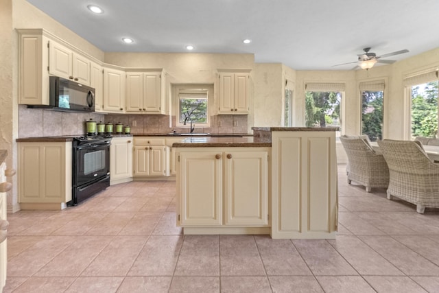 966 S Carriage Ave, Springfield, MO 65809 - kitchen featuring black appliances, decorative backsplash, cream cabinetry, ceiling fan, and light tile patterned flooring