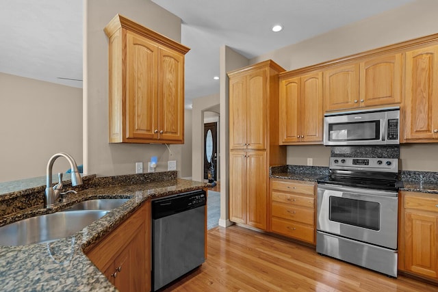 628 N Alexandria St, Nixa, MO 65714 - kitchen with stainless steel appliances, dark stone countertops, light wood-style flooring, and recessed lighting