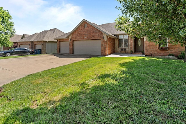 628 N Alexandria St, Nixa, MO 65714 - view of front of home featuring an attached garage, a front lawn, brick siding, and concrete driveway