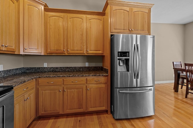 628 N Alexandria St, Nixa, MO 65714 - kitchen featuring stainless steel refrigerator with ice dispenser, range, light wood finished floors, and dark stone countertops