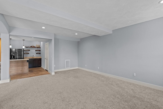 628 N Alexandria St, Nixa, MO 65714 - unfurnished living room featuring light colored carpet, wet bar, and recessed lighting