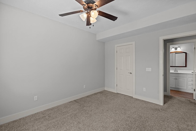 628 N Alexandria St, Nixa, MO 65714 - unfurnished bedroom featuring carpet floors, connected bathroom, and a ceiling fan