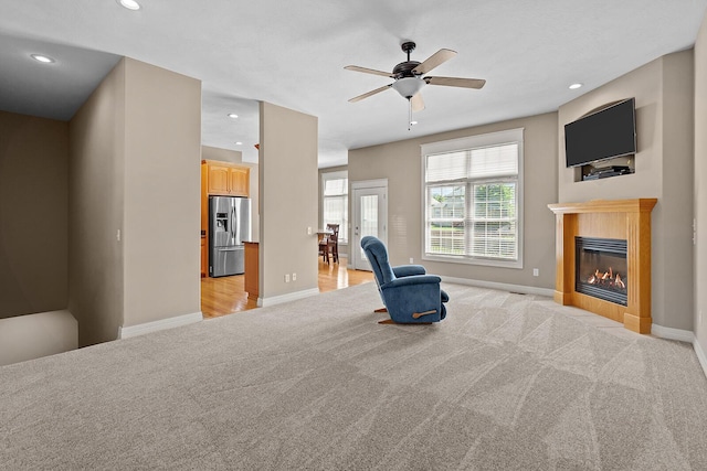 628 N Alexandria St, Nixa, MO 65714 - living area featuring light carpet, ceiling fan, a glass covered fireplace, and recessed lighting