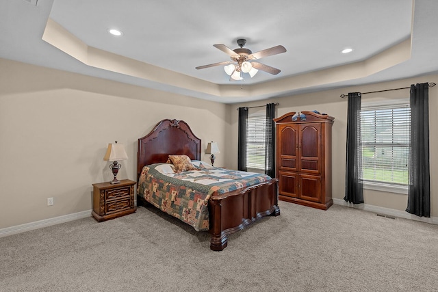 628 N Alexandria St, Nixa, MO 65714 - carpeted bedroom featuring a tray ceiling, multiple windows, a ceiling fan, and recessed lighting