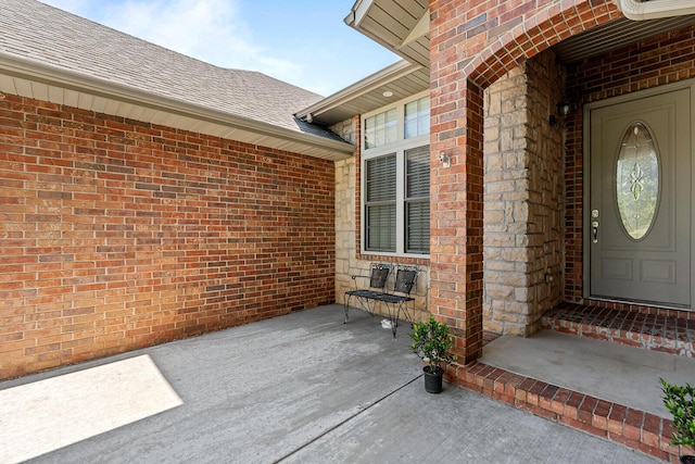628 N Alexandria St, Nixa, MO 65714 - view of exterior entry featuring brick siding and a shingled roof