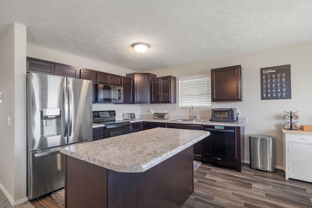460 Hudson Ave, Republic, MO 65738 - kitchen featuring black appliances, dark brown cabinetry, light countertops, a center island, and a textured ceiling