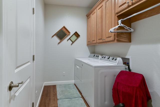 21791 Mill Creek Dr, Shell Knob, MO 65747 - laundry area featuring washer and dryer, cabinet space, and wood finished floors