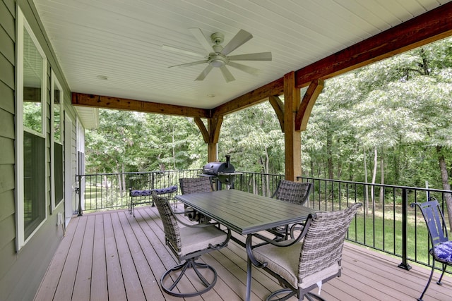 21791 Mill Creek Dr, Shell Knob, MO 65747 - wooden terrace featuring outdoor dining area, a ceiling fan, and view of wooded area