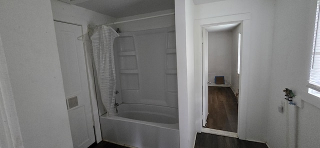 2351 E Pacific St, Springfield, MO 65803 - bathroom with shower / bath combination with curtain and wood finished floors
