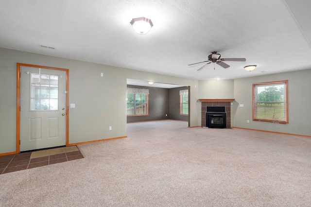 136 Cedar Dale Ln, Ozark, MO 65721 - unfurnished living room with ceiling fan, carpet floors, and a fireplace