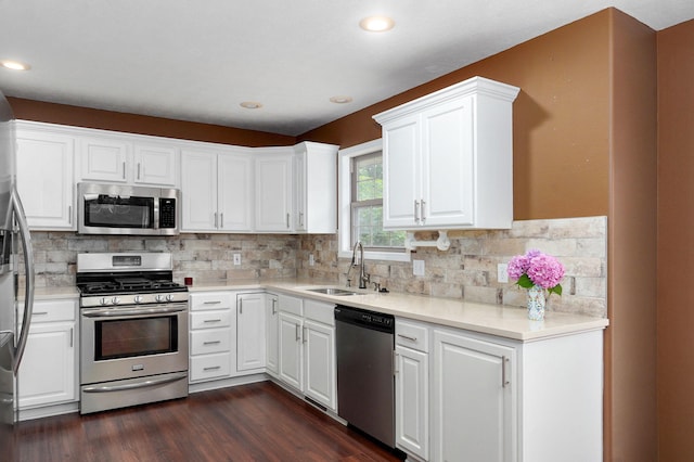 136 Cedar Dale Ln, Ozark, MO 65721 - kitchen with stainless steel appliances, dark wood-style floors, white cabinetry, tasteful backsplash, and recessed lighting