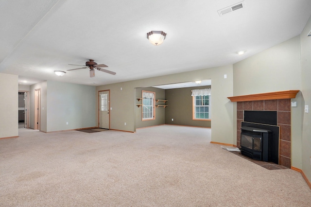 136 Cedar Dale Ln, Ozark, MO 65721 - unfurnished living room featuring carpet floors, a ceiling fan, and a wood stove