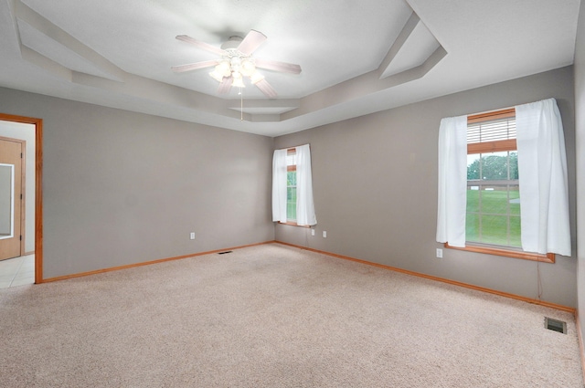 136 Cedar Dale Ln, Ozark, MO 65721 - spare room with light carpet, plenty of natural light, a ceiling fan, and a tray ceiling