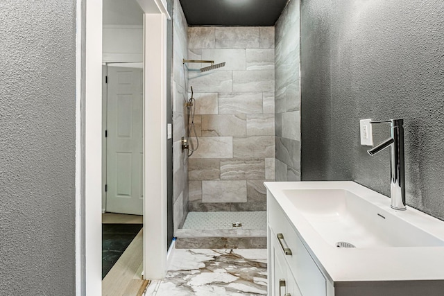 189 Walnut St, Sparta, MO 65753 - full bath with a textured wall, tiled shower, marble look tile flooring, and vanity