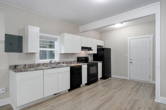 619 N Nettleton Ave, Springfield, MO 65802 - kitchen with black appliances, electric panel, light wood-style flooring, white cabinets, and under cabinet range hood