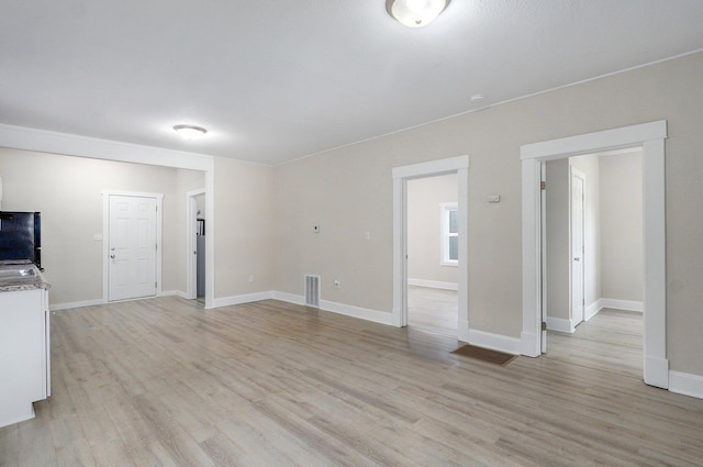 619 N Nettleton Ave, Springfield, MO 65802 - unfurnished living room featuring light wood-style flooring