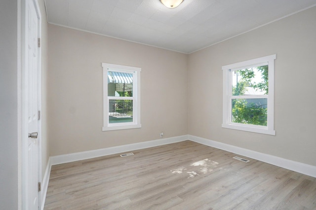 619 N Nettleton Ave, Springfield, MO 65802 - spare room featuring healthy amount of natural light, crown molding, and light wood-style flooring