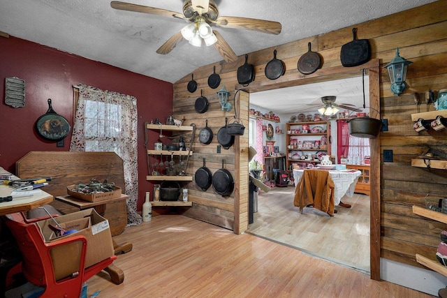106 S Gilmore St, Miller, MO 65707 - office area with a ceiling fan, lofted ceiling, wood finished floors, wooden walls, and a textured ceiling
