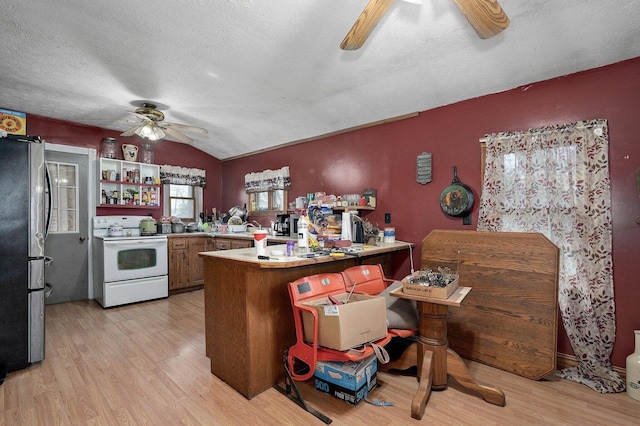 106 S Gilmore St, Miller, MO 65707 - kitchen featuring white electric stove, ceiling fan, freestanding refrigerator, a peninsula, and light wood-type flooring
