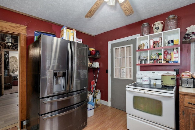 106 S Gilmore St, Miller, MO 65707 - kitchen with stainless steel fridge, white electric stove, light wood finished floors, a ceiling fan, and a textured ceiling