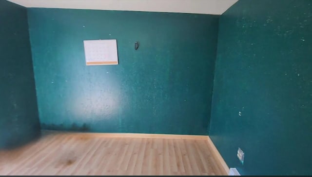 6424 W Farm Rd Unit 140, Springfield, MO 65802 - spare room with baseboards and wood finished floors