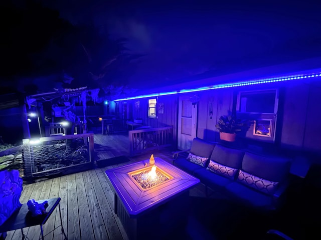 6424 W Farm Rd Unit 140, Springfield, MO 65802 - deck at night featuring an outdoor living space with a fire pit