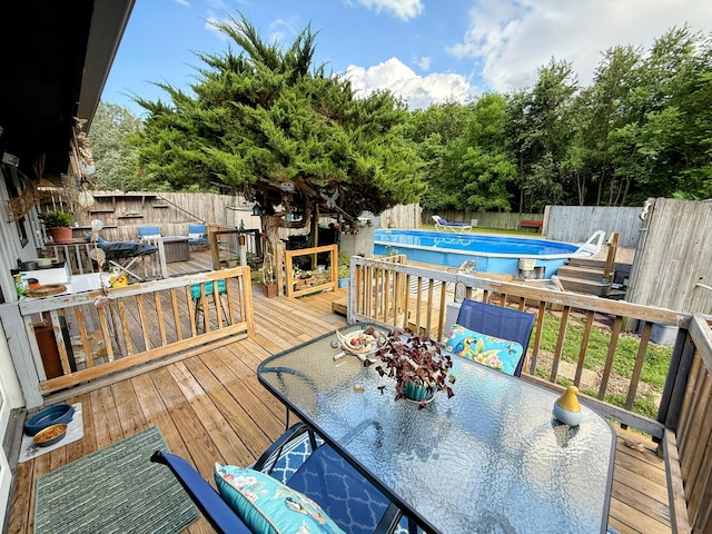 6424 W Farm Rd Unit 140, Springfield, MO 65802 - wooden deck featuring outdoor dining area, a fenced backyard, and view of wooded area