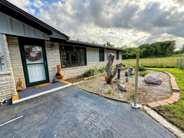 6424 W Farm Rd Unit 140, Springfield, MO 65802 - doorway to property featuring stone siding