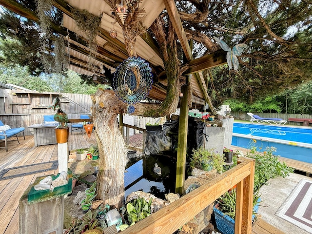 6424 W Farm Rd Unit 140, Springfield, MO 65802 - wooden deck featuring a garden pond
