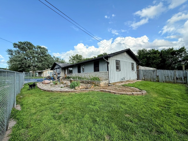 6424 W Farm Rd Unit 140, Springfield, MO 65802 - back of house featuring board and batten siding and a fenced backyard