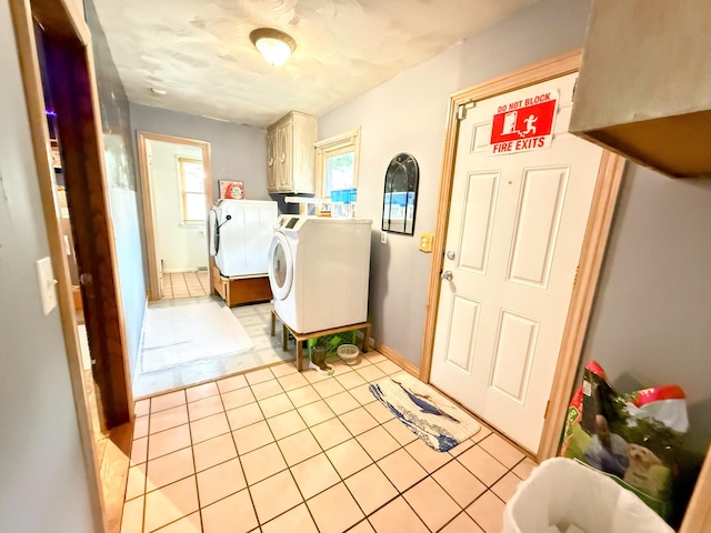 6424 W Farm Rd Unit 140, Springfield, MO 65802 - laundry area with washer and clothes dryer, cabinet space, and light tile patterned flooring