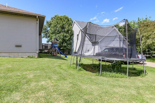 828 S Chinkapin Ave, Nixa, MO 65714 - view of grassy yard featuring a trampoline and a playground