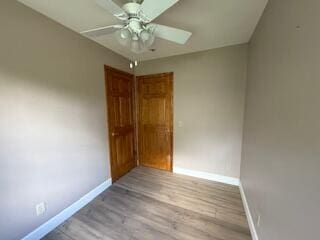 5125 S Walnut Hill Rd, Springfield, MO 65810 - empty room with a ceiling fan and wood finished floors