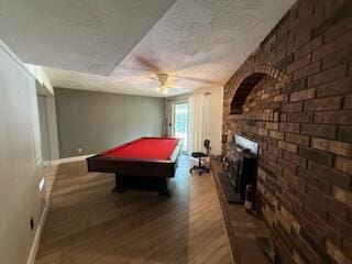 5125 S Walnut Hill Rd, Springfield, MO 65810 - game room with wood finished floors, brick wall, a ceiling fan, billiards table, and a textured ceiling