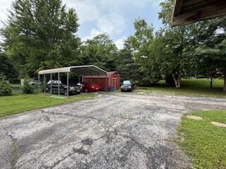 5125 S Walnut Hill Rd, Springfield, MO 65810 - view of car parking with a carport and driveway