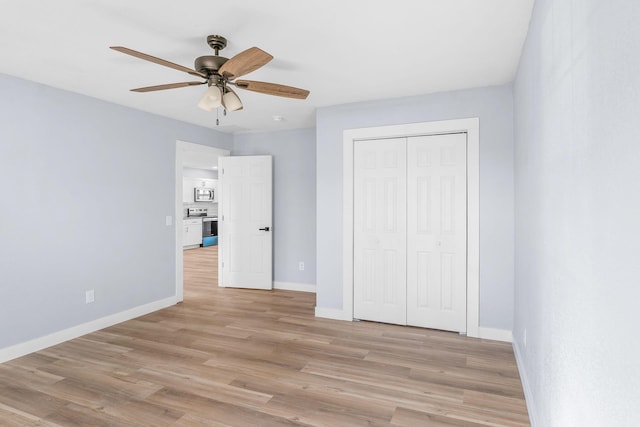 305 Crescent St, Aurora, MO 65605 - unfurnished bedroom with light wood finished floors, a closet, and a ceiling fan