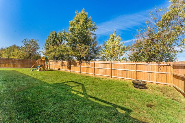 2801 E Bradford St, Republic, MO 65738 - fenced backyard featuring a playground and a fire pit