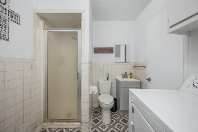 212 N School St, Goodman, MO 64843 - full bath with washer / dryer, tile walls, a shower stall, wainscoting, and vanity