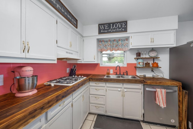 212 N School St, Goodman, MO 64843 - kitchen with dishwasher, white gas stovetop, wood counters, white cabinets, and tasteful backsplash