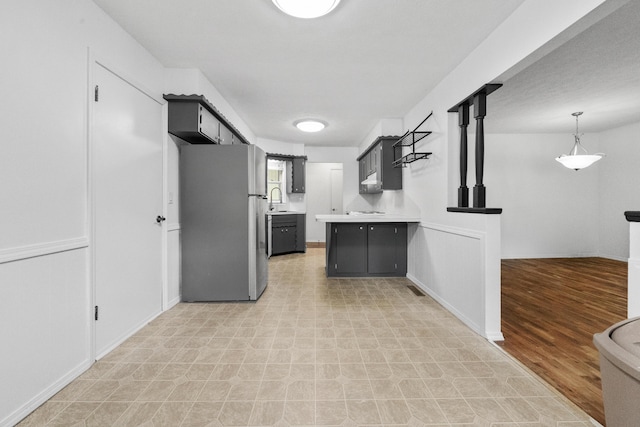 1541 E Crestview St, Springfield, MO 65804 - kitchen featuring freestanding refrigerator, light countertops, light flooring, dark cabinets, and open floor plan