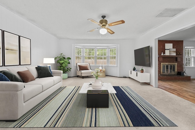 1541 E Crestview St, Springfield, MO 65804 - living room with ceiling fan, carpet floors, and a brick fireplace