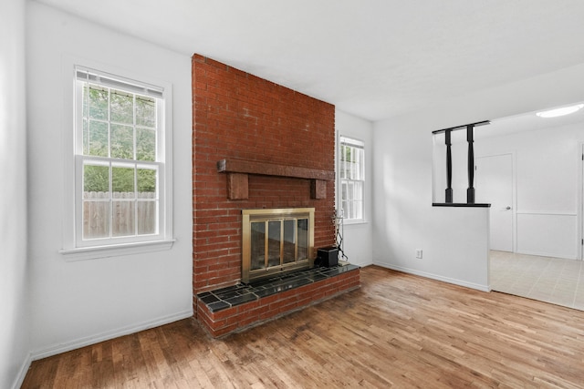 1541 E Crestview St, Springfield, MO 65804 - unfurnished living room with plenty of natural light, wood finished floors, and a brick fireplace